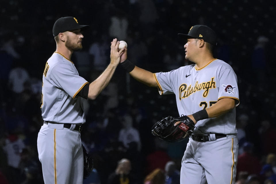 Pittsburgh Pirates relief pitcher Chris Stratton, left, and first baseman Yoshi Tsutsugo celebrate the team's 4-3 win over the Chicago Cubs after a baseball game Thursday, April 21, 2022, in Chicago. (AP Photo/Charles Rex Arbogast)