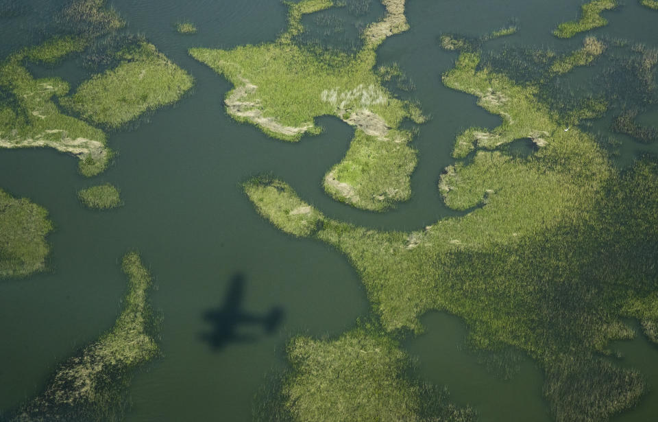 A Cajun Air seaplane travels over the marsh as the search continues for the missing Seacor Power crew members, near Lake Pelto in Terrebonne Parish, La., on Thursday, April 29, 2021. Nineteen people were on the Seacor Power when it capsized April 13. Six people were rescued and six bodies have been recovered. (Sophia Germer/The Advocate via AP)