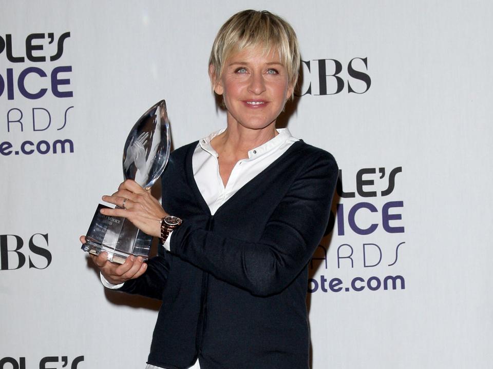 TV personality Ellen DeGeneres poses with the Favorite Talk Show Host award in the press room at the 35th Annual People's Choice Awards