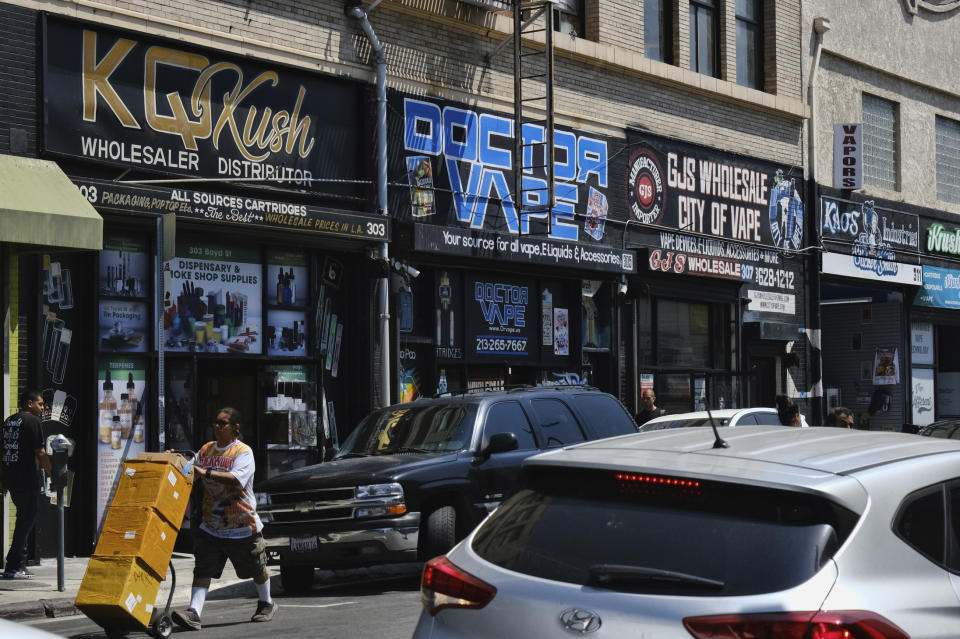 This Wednesday, Aug. 28, 2019, photo shows a bustling street lined with wholesale vape shops in downtown Los Angeles. A short walk from police headquarters in the heart of downtown, a cluster of bustling shops are openly selling packaging and hardware that can be used to produce counterfeit, and potentially dangerous, marijuana vapes that have infected California's cannabis market and possibly sickened dozens of people. (AP Photo/Richard Vogel)