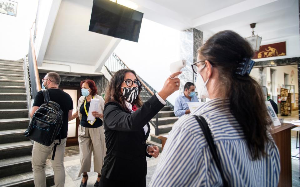 Staff taking temperature before entering as the professional Institute J.B.Beccari in Turin presents new procedures, signs and rules in order to contain the spread of the pandemic - Getty Images Europe 