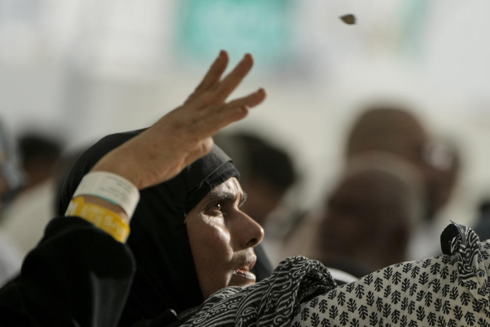 Pilgrims cast stones at a pillar in the symbolic stoning of the devil, the last rite of the annual Hajj pilgrimage, in Mina near the holly city of Mecca, Saudi Arabia, Wednesday, June 28, 2023. (AP Photo/Amr Nabil)