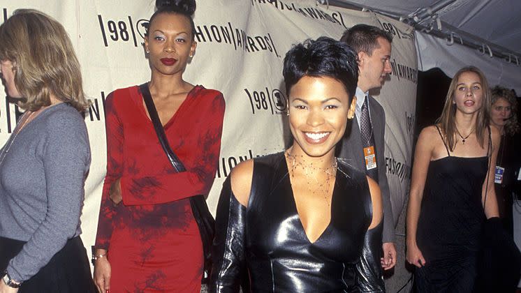 best 90s fashion trends, woman, nia long, wearing a black leather dress