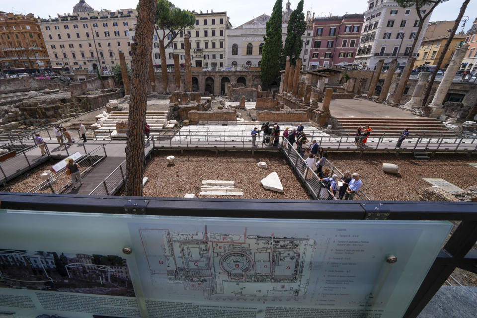 Journalists visit the new walkways of the so called 'Sacred Area' where four temples, dating back as far as the 3rd century B.C., stand smack in the middle of one of modern Rome's busiest crossroads, Monday, June 19, 2023, With the help of funding from Bulgari, the luxury jeweler, the grouping of temples can now be visited by the public that for decades had to gaze down from the bustling sidewalks rimming Largo Argentina (Argentina Square) to admire the temples below where Julius Caesar masterminded his political strategies and was later fatally stabbed in 44 B.C. (AP Photo/Domenico Stinellis)