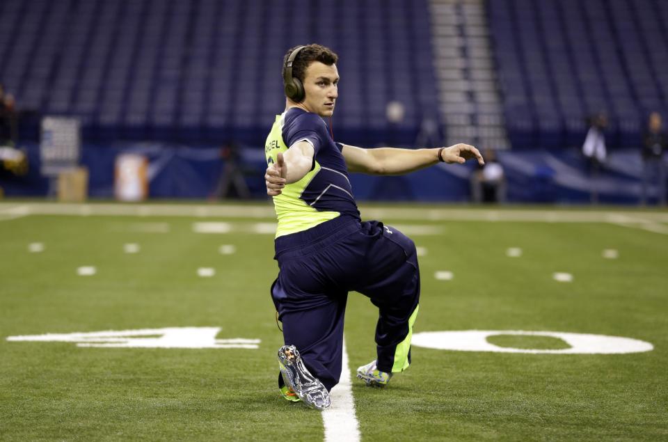 Texas A&M quarterback Johnny Manziel warms up before running the 40-yard dash at the NFL football scouting combine in Indianapolis, Sunday, Feb. 23, 2014. (AP Photo/Michael Conroy)