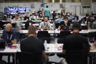 FILE - In this July 20, 2021, file photo, journalists work between plastic barriers in the main press center at the 2020 Summer Olympics, in Tokyo. (AP Photo/David Goldman, File)
