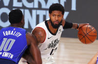 Los Angeles Clippers' Paul George, right, looks to pass against Dallas Mavericks' Dorian Finney-Smith (10) during the fourth quarter of Game 3 of an NBA basketball first-round playoff series, Friday, Aug. 21, 2020, in Lake Buena Vista, Fla. (Mike Ehrmann/Pool Photo via AP)