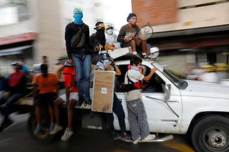 Demonstrators ride on a truck during a rally against Venezuela's President Nicolas Maduro in Caracas, Venezuela, May 31, 2017. REUTERS/Carlos Garcia Rawlins