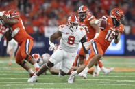 Clemson defensive tackle Tre Williams (8) chase Syracuse quarterback Garrett Shrader (16) during the first quarter of an NCAA football game in Syracuse, N.Y., Friday, Oct. 15, 2021. (AP Photo/Joshua Bessex)