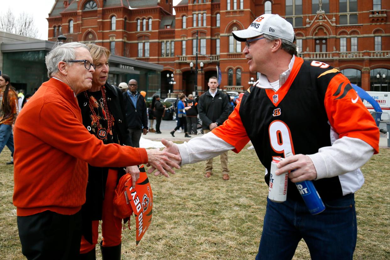 Ohio Gov. Mike DeWine and Ohio First Lady Fran DeWine greet a Cincinnati Bengals fan during a fan rally celebrating the team's Super Bowl 56 appearance at Washington Park in the Over-the-Rhine neighborhood of Cincinnati on Wednesday, Feb. 16, 2022.