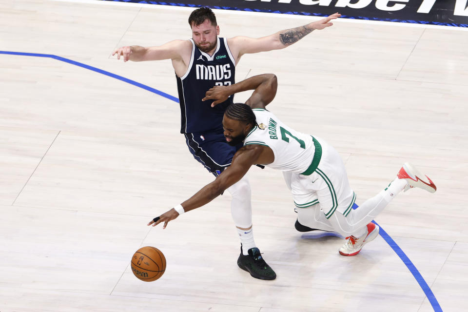 Dallas, TX - 6/12/24 - Dallas Mavericks guard Luka Doncic (77) fouls out of the game during this play with Boston Celtics guard Jaylen Brown (7) during the fourth quarter in Game 3 of the NBA Finals. The Dallas Mavericks hosted the Boston Celtics at American Airlines Center on Wednesday, June 12, 2024. (Photo by Danielle Parhizkaran/The Boston Globe via Getty)