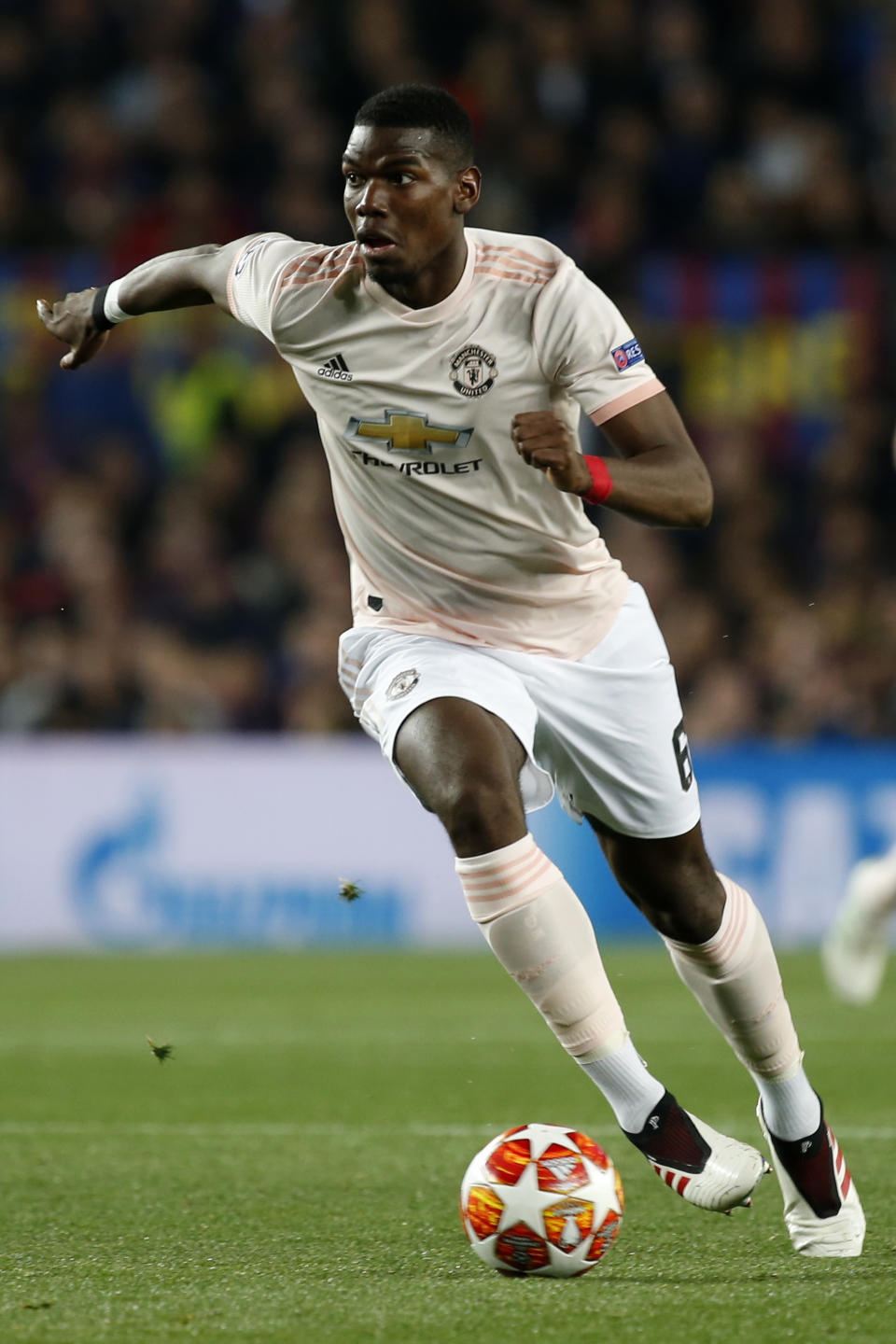 Manchester United's Paul Pogba runs with the ball during the Champions League quarterfinal, second leg, soccer match between FC Barcelona and Manchester United at the Camp Nou stadium in Barcelona, Spain, Tuesday, April 16, 2019. (AP Photo/Joan Monfort)