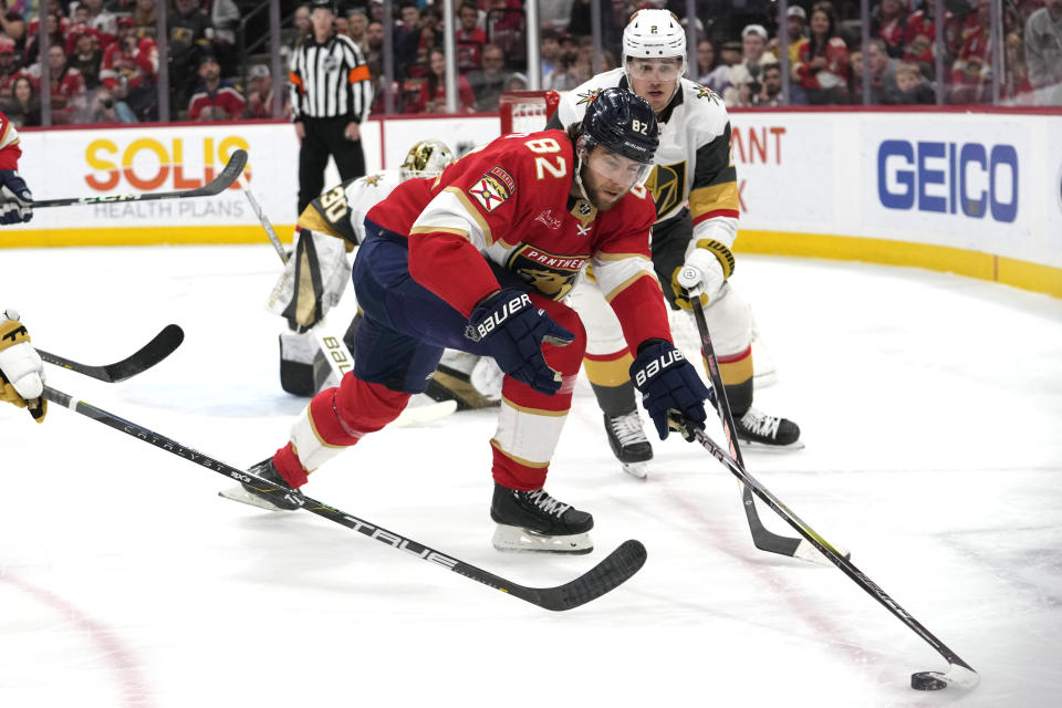 Florida Panthers center Kevin Stenlund (82) and Vegas Golden Knights defenseman Zach Whitecloud (2) go for the puck during the second period of an NHL hockey game, Saturday, Dec. 23, 2023, in Sunrise, Fla. (AP Photo/Lynne Sladky)