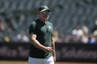 Oakland Athletics manager Mark Kotsay walks to the dugout after making a pitching change during the seventh inning of the team's baseball game against the Pittsburgh Pirates in Oakland, Calif., Wednesday, May 1, 2024. (AP Photo/Jeff Chiu)
