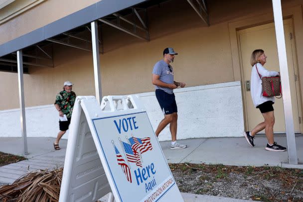 PHOTO: Voters arrive to cast their ballots at a polling station setup in the Lee County Election Headquarters building on Oct. 24, 2022, in Fort Myers, Fla. (Joe Raedle/Getty Images)