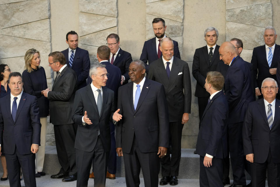 United States Secretary of Defense Lloyd Austin, front center right, speaks with NATO Secretary General Jens Stoltenberg, front center left, during a group photo of NATO defense ministers at NATO headquarters in Brussels, Friday, June 14, 2024. (AP Photo/Virginia Mayo)