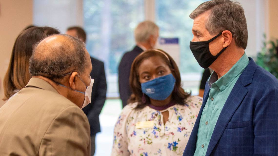 Governor Roy Cooper talks with Wake County Commissioners James West and Shinica Thomas following a press briefing on COVID-19 on Thursday, September 29, 2021 at Health Park Pharmacy in Raleigh, N.C.