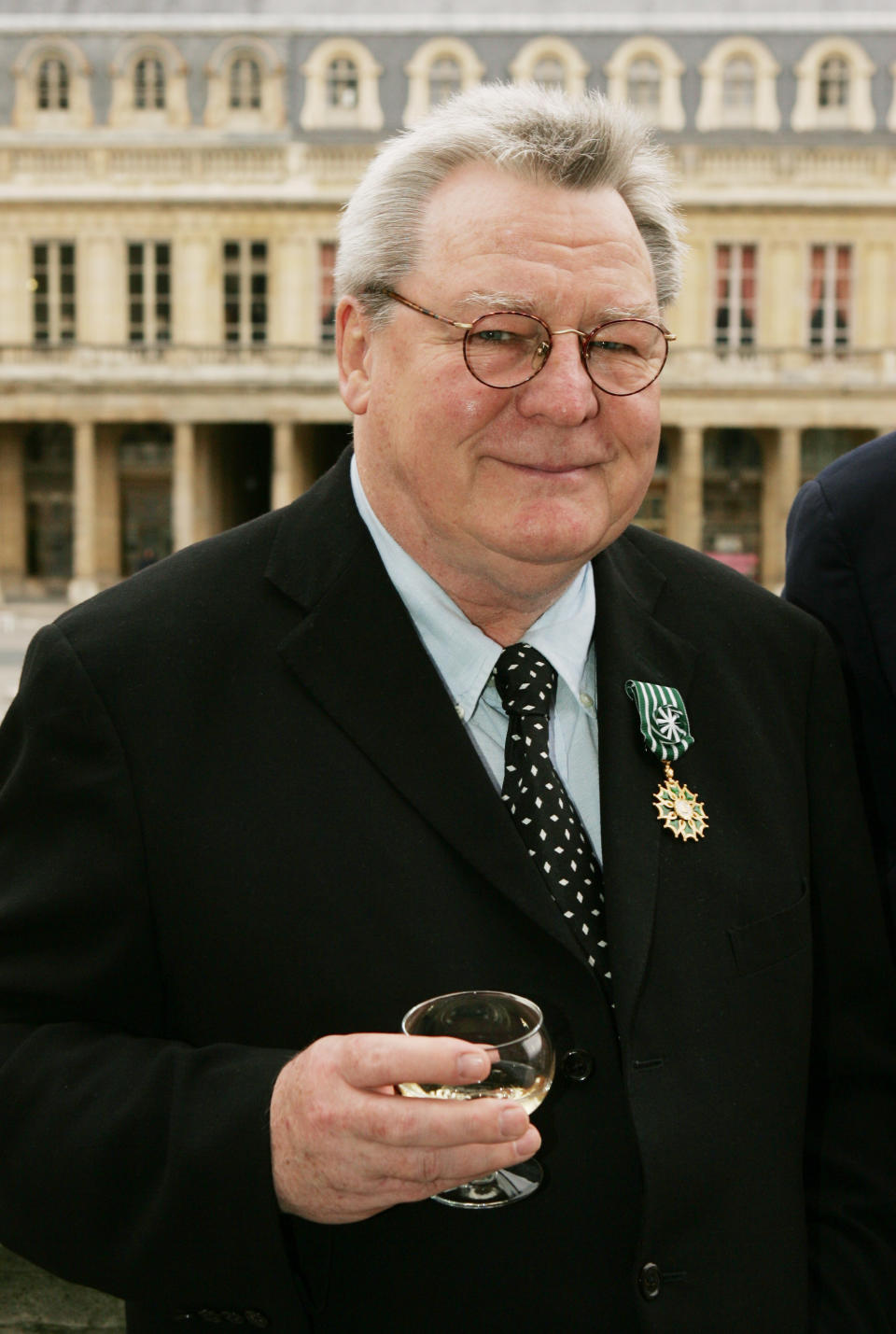 British film director Sir Alan Parker displays his "Officier des Arts et Lettres" medal awarded to him for his contribution to cinema