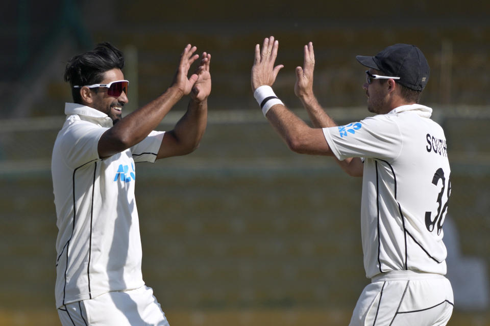 New Zealand's Ish Sodhi, left, celebrates with Tim Southee after taking the wicket of Pakistan's Imam-ul-Haq during the fifth day of the second test cricket match between Pakistan and New Zealand, in Karachi, Pakistan, Friday, Jan. 6, 2023. (AP Photo/Fareed Khan)