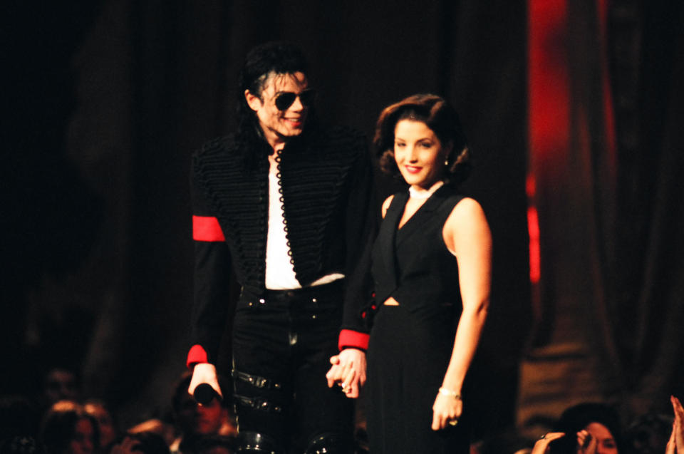Michael Jackson and Lisa Marie Presley hold hands on stage
