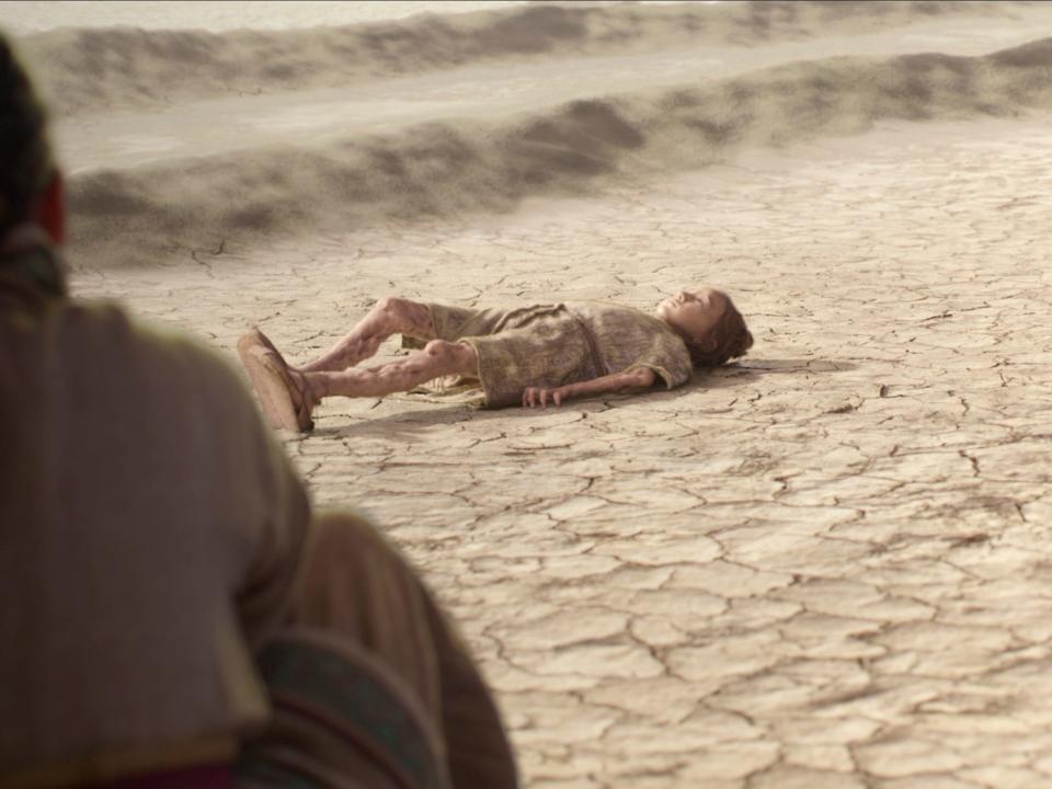 follower, a young child, laying on the ground. her limbs look thin and her leg is bent at an unnerving level as the water seemingly leeches out of her body