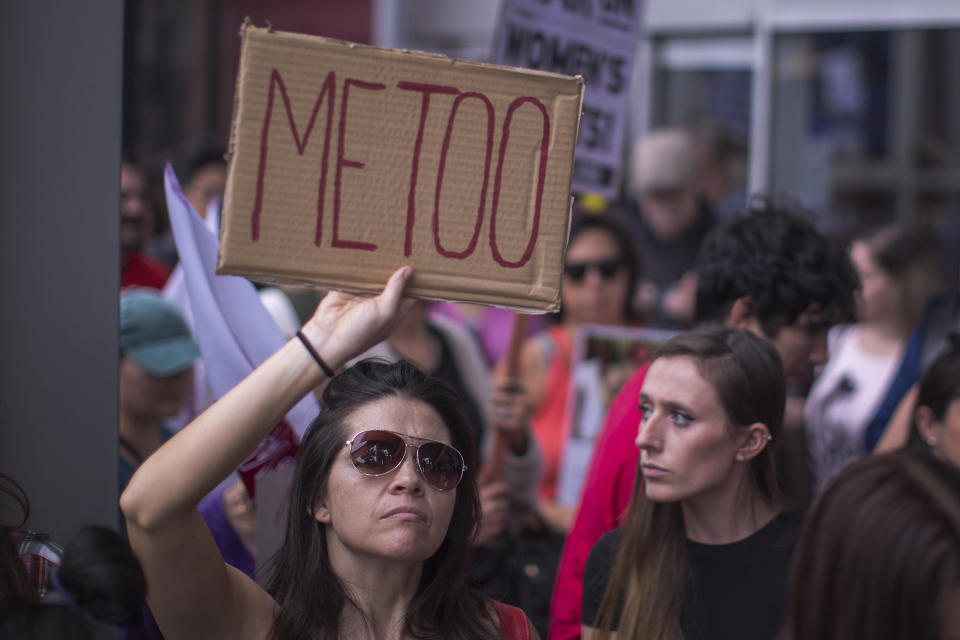 One woman holds a sign echoing the #MeToo social media campaign.&nbsp;