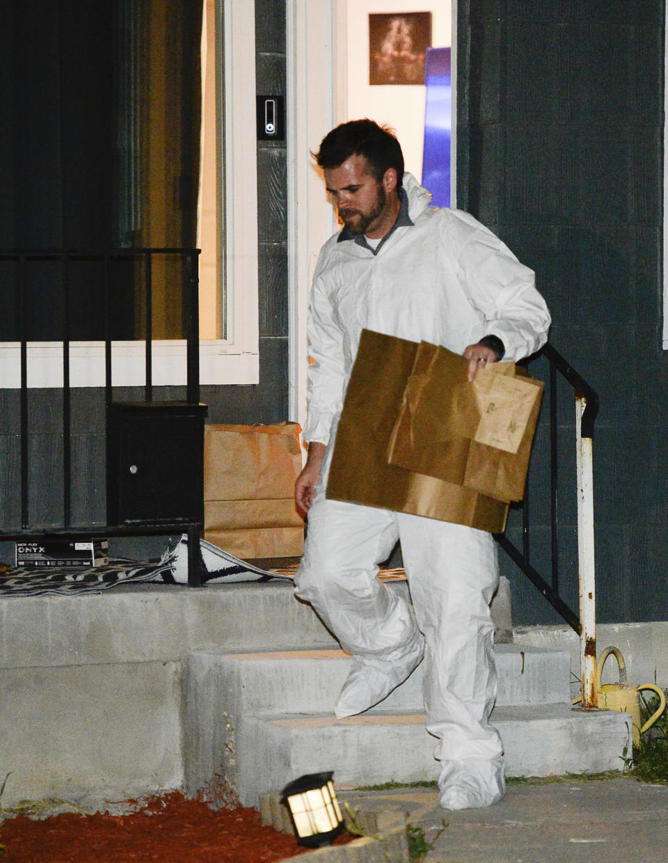 Police investigators remove multiple bags of evidence during their search of a home in Salt Lake City as part of the disappearance of University of Utah student MacKenzie Lueck that carried on into the early morning hours of Thursday, June 27, 2019. (Francisco Kjolseth/The Salt Lake Tribune via AP)