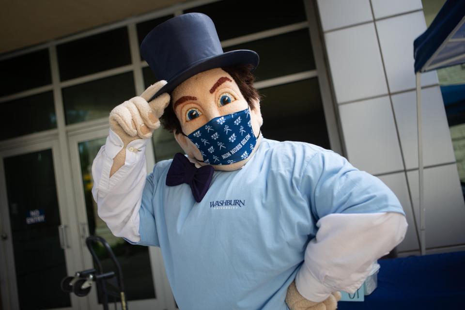 The Washburn Icabod wears one of the face masks that all students attending the university in the fall will receive during move-in day Tuesday afternoon in front of the Living Learning Center.