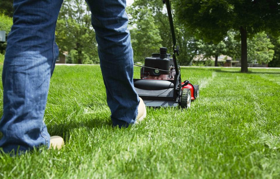 Vstock / Getty Images Man mowing lawn in a stock photo