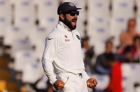 Cricket - India v England - Third Test cricket match - Punjab Cricket Association Stadium, Mohali, India - 26/11/16. India's Virat Kohli celebrates the dismissal of England's Jos Buttler. REUTERS/Adnan Abidi