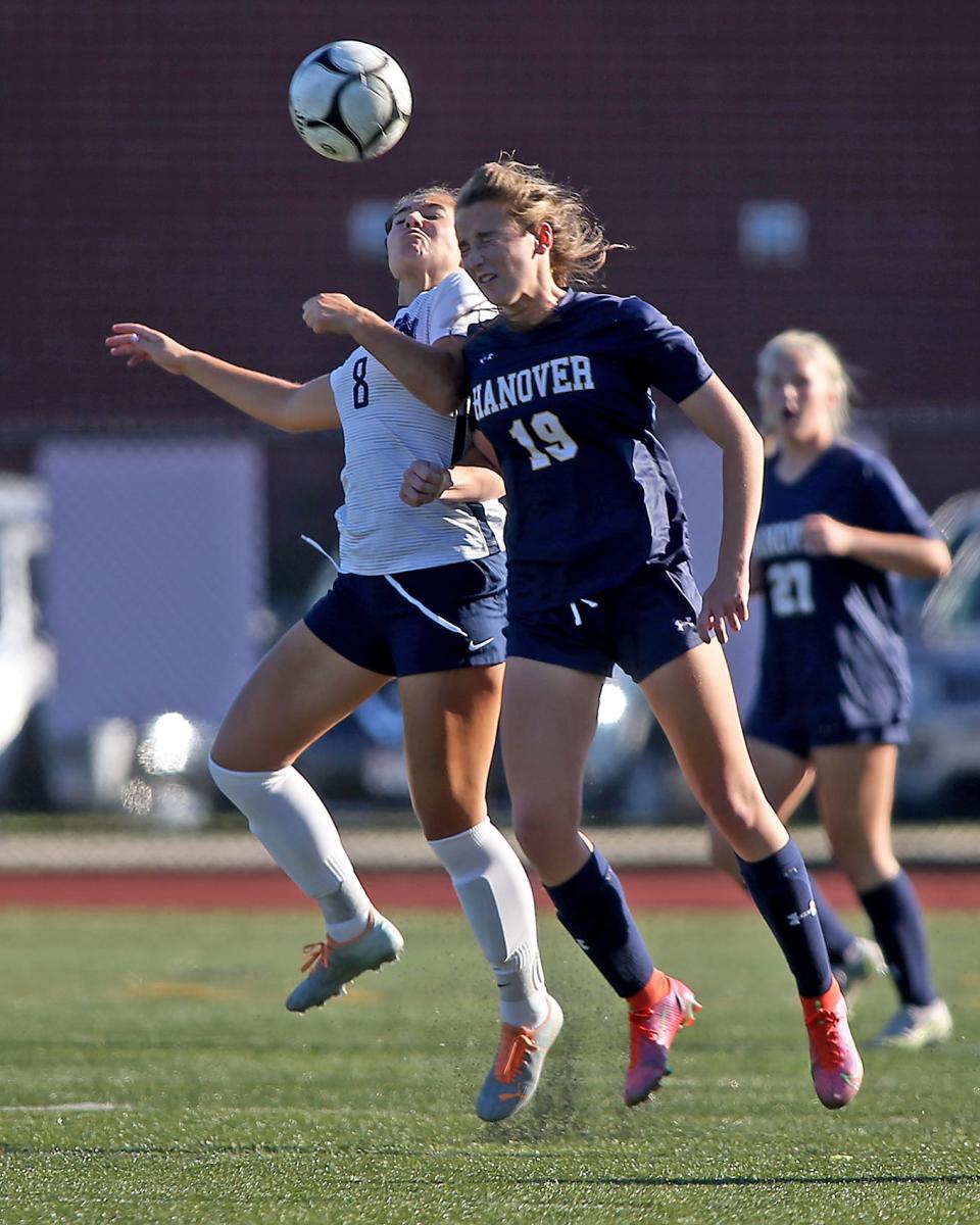 Hanover’s Eva Kelliher looks to win the 50/50 ball over Plymouth North’s Emma Rush during first law action of their game against Plymouth North at Hanover High on Thursday, Sept. 15, 2022.