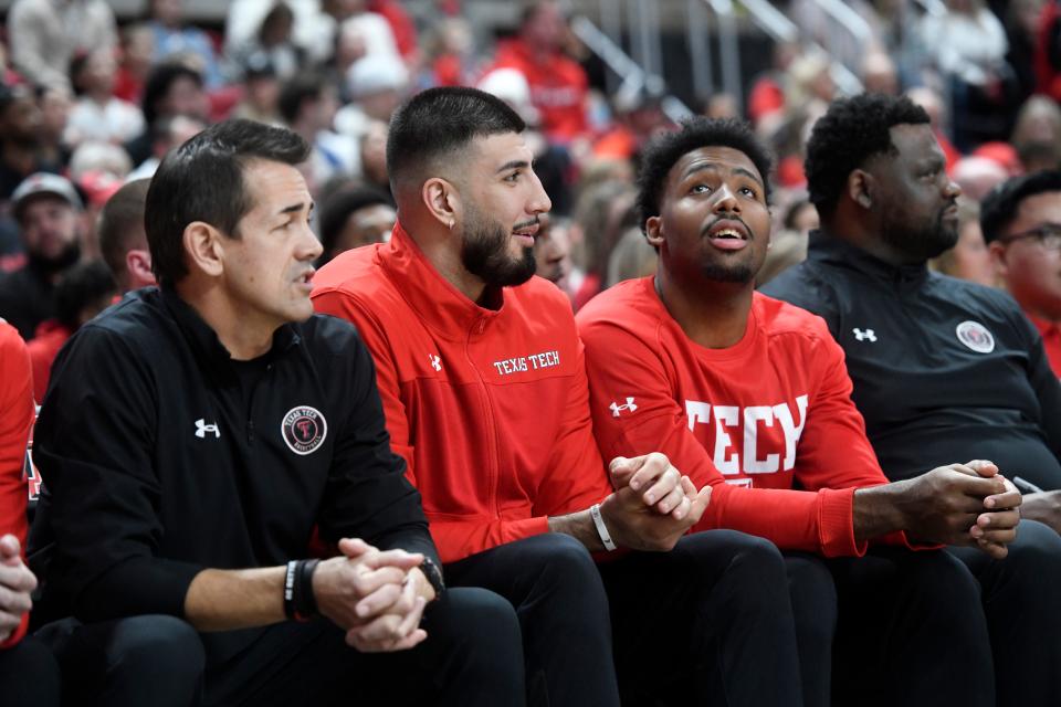 Texas Tech's forward Fardaws Aimaq, center, and Texas Tech's forward KJ Allen, right, sit on the bench during the Oklahoma Big 12 basketball game, Saturday, Jan. 7, 2023, at United Supermarkets Arena. 