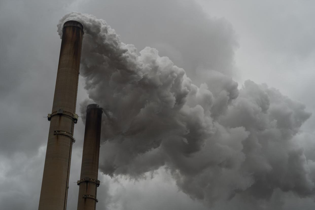 Smoke billows out of the stacks at a coal power plant on Monday, Dec. 21, 2020 in Cheshire, Ohio.