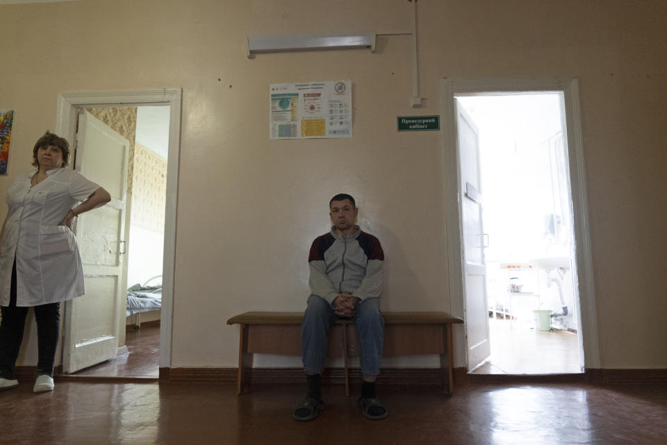 Oleksandr, a patient, sits in a corridor at a psychiatric hospital In Kramatorsk, Ukraine, Tuesday March 21, 2023. In December, the World Health Organization said one in five people in countries that have experienced conflict in the past decade will suffer from a mental health condition, and estimated that about 9.6 million people in Ukraine could be affected. Russia’s invasion in February 2022 resulted in millions of people being displaced, bereaved, forced into basements for months due to incessant shelling or enduring harrowing journeys from Russian-occupied regions. (AP Photo/Vasilisa Stepanenko)