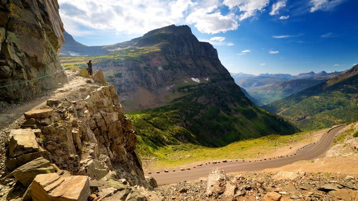<span class="article__caption">A hiker looks out from above Going-To-The-Sun Road, Glacier National Park, in summer.</span> (Photo: Anna Gorin/Getty)