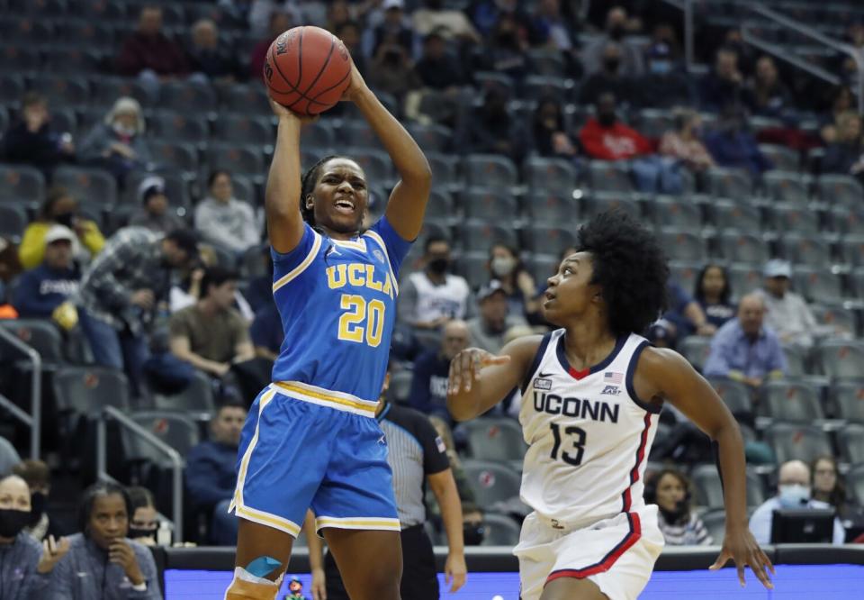 UCLA guard Charisma Osborne shoots over Connecticut guard Christyn Williams on Dec. 11.