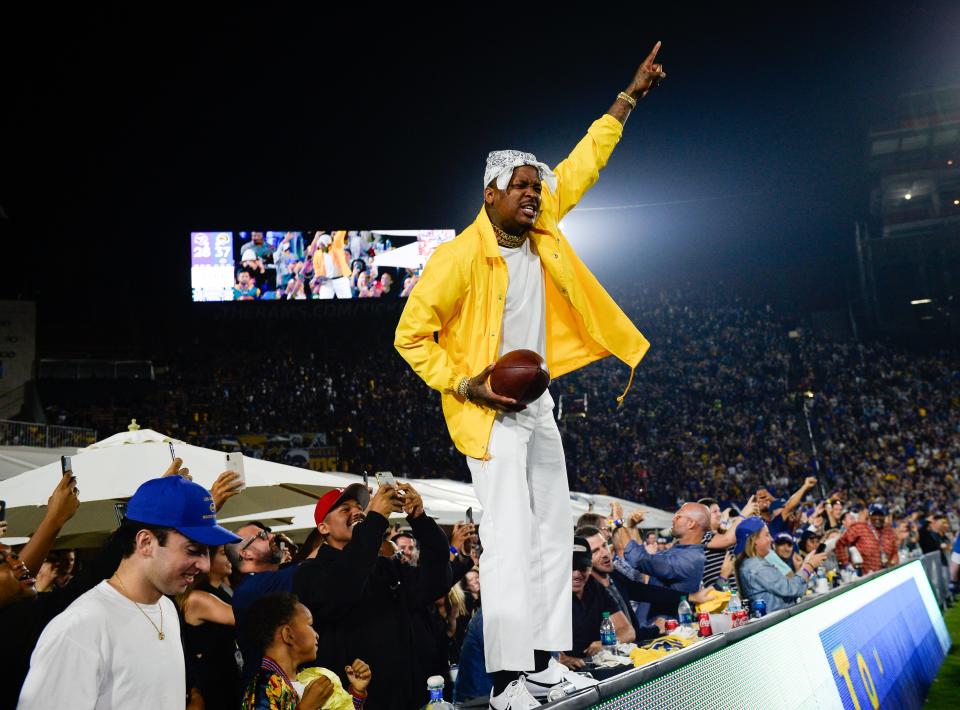 LOS ANGELES, CA - SEPTEMBER 27: Rapper YG stands and cheers with fans at the Los Angeles Rams game against the Minnesota Vikings at Los Angeles Memorial Coliseum on September 27, 2018 in Los Angeles, California. (Photo by Kevork Djansezian/Getty Images) ORG XMIT: 775192612 ORIG FILE ID: 1042173562