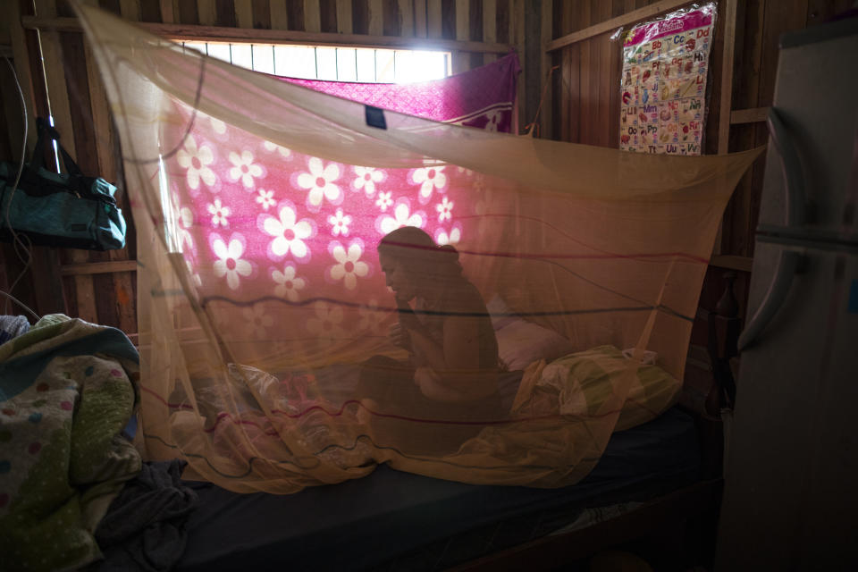 Julia Lina who has been suffering from COVID-19 symptoms, rests in her bed enclosed in mosquito netting after receiving an herbal treatment from Comando Matico volunteers, in the Shipibo Indigenous community of Pucallpa, in Peru’s Ucayali region, Tuesday, Sept. 1, 2020. Decades of underinvestment in public health care, combined with skepticism of modern medicine, mean many are not getting standard treatments like oxygen therapy to treat severe virus cases. (AP Photo/Rodrigo Abd)