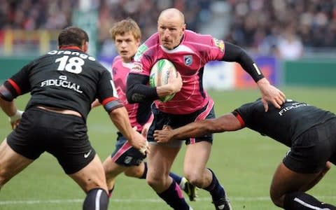 Cardiff winger Gareth Thomas (C) vies with Toulouse's opponents during their European Cup rugby union match Toulouse vs Cardiff - Credit: Pascal Pavani/AFP