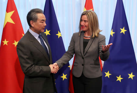 Chinese Foreign Minister Wang Yi is welcomed by EU High Representative for Foreign Affairs and Security Policy Federica Mogherini ahead of a meeting in Brussels, Belgium March 18, 2019. REUTERS/Yves Herman