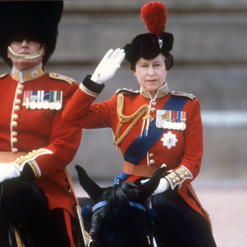 Queen Elizabeth II taking the salute of the Household Guards regiments during the Trooping of the Colour ceremony in London, 1985 (PA)