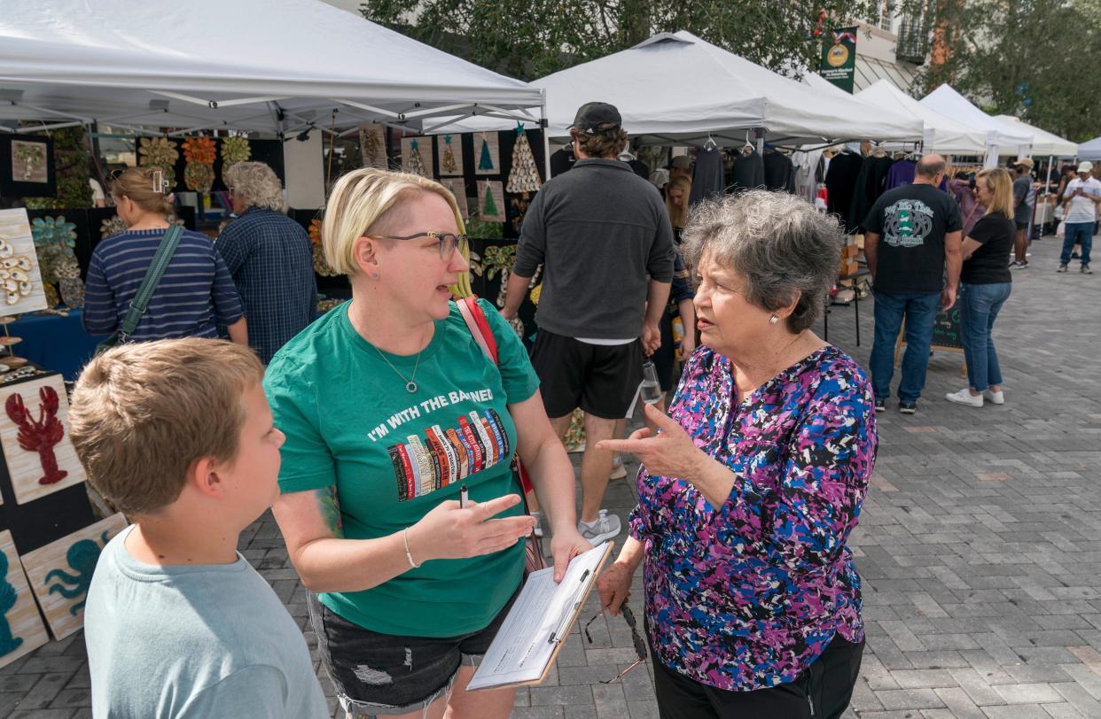 U.S. Rep. Lois Frankel talks to Sara Windrem, center, and her son Owen, 9, while gathering signatures for a petition to allow access to legal abortion in Florida.