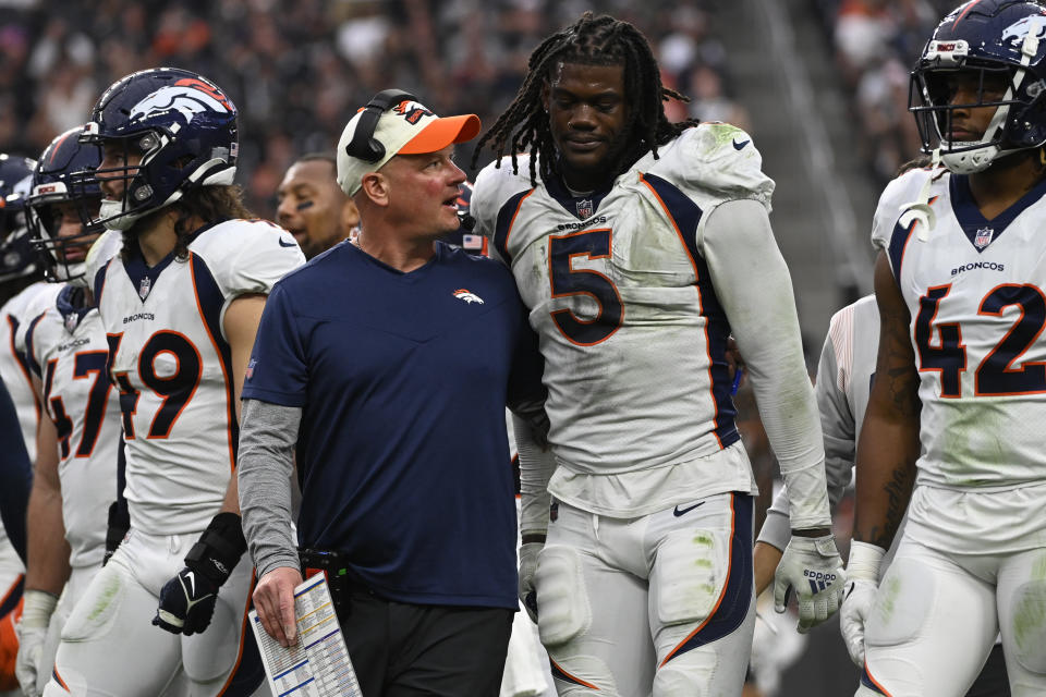 Denver Broncos head coach Nathaniel Hackett talks with linebacker Randy Gregory (5) during the second half of an NFL football game against the Las Vegas Raiders, Sunday, Oct. 2, 2022, in Las Vegas. (AP Photo/David Becker)