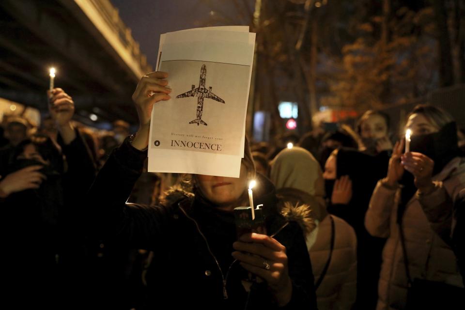 FILE - In this Jan. 11, 2020 file photo, people gather for a candlelight vigil to remember the victims of the Ukraine plane crash, at the gate of Amri Kabir University in Tehran, Iran. After a yearlong investigation, Iran's civil aviation agency on Wednesday released its final report on the crash of a Ukrainian passenger plane that killed 176 people last January, revealing no new details about the shootdown that has provoked outrage from affected countries and concerns from U.N. investigators. (AP Photo/Ebrahim Noroozi, File)