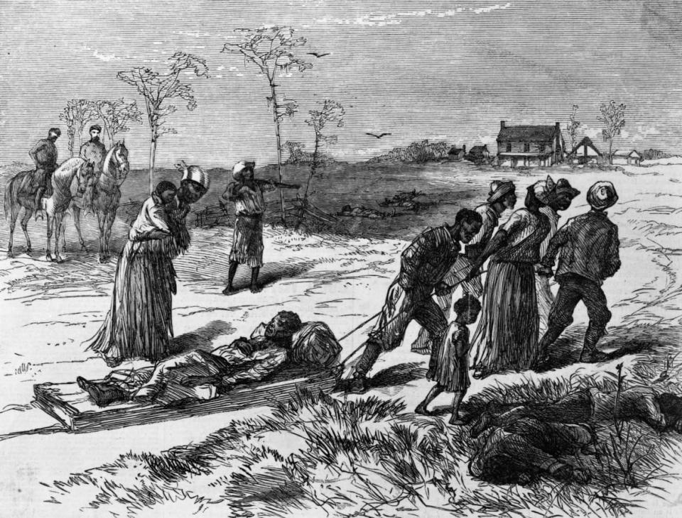 Blacks residents of Colfax, Louisiana gather the dead and wounded from the 1873 “Colfax Massacre.” (Published in Harper’s Weekly; Photo by MPI/Getty Images)