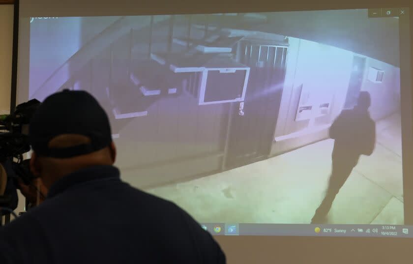 Stockton Police show a a brief video from a surveillance camera of an image of what authorities describe as a "person of interest," in the investigation into a suspected serial killer during a news conference in Stockton, Calif., Tuesday, Oct. 4, 2022. Ballistics tests have linked the fatal shootings of six men and the wounding of one woman in California — all potentially at the hands of a serial killer — in crimes going back more than a year, police said. (AP Photo/Rich Pedroncelli)