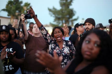 Protesters gather at the El Cajon Police Department headquarters to protest the fatal shooting of an unarmed black man on Tuesday by officers in El Cajon, California, U.S. September 28, 2016. REUTERS/Sandy Huffaker