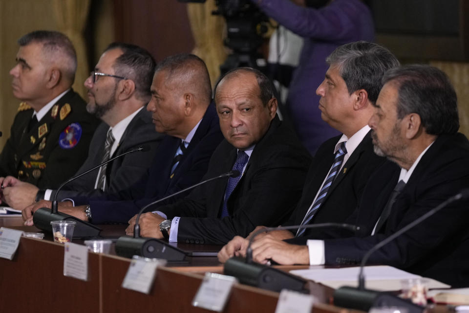 Alexis Rodriguez Cabello, center, whose title is "Only Authority for Guayana Esequiba," attends a meeting with other government representatives at the Foreign Ministry in Caracas, Venezuela, Monday, Dec. 11, 2023. Leaders of Guyana and Venezuela are preparing to meet this week to address an escalating dispute over the Essequibo region that is rich in oil and minerals. (AP Photo/Matias Delacroix)