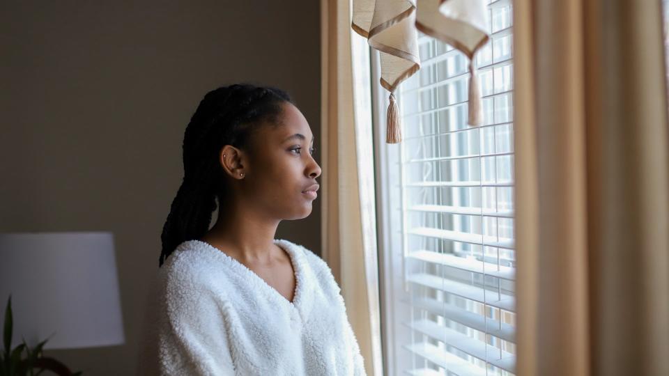 African-American teenaged girl sad and lonely.