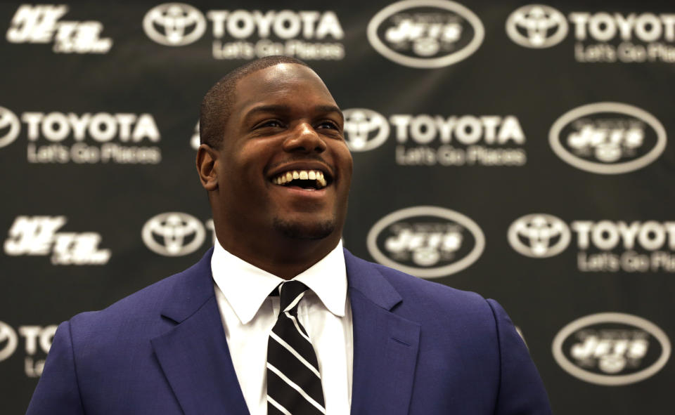 FILE - New York Jets' D'Brickashaw Ferguson laughs while speaking to the media about retirement during a press conference on Thursday, April 14, 2016, at the team's practice facility in Florham Park, N.J. The Jets will induct former cornerback Darrelle Revis, center Nick Mangold and left tackle D'Brickashaw Ferguson into the team's Ring of Honor during separate halftime ceremonies this season. The team announced Thursday, June 2, 2022, that Mangold will be the first honored with a ceremony during the Jets' game against Cincinnati on Sept. 25. Ferguson's induction will be Oct. 30 against New England, and Revis' will be Nov. 27 against Chicago. (AP Photo/Adam Hunger, File)